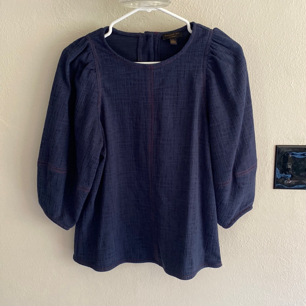 Soft top with puffed sleeves. Cute button back.